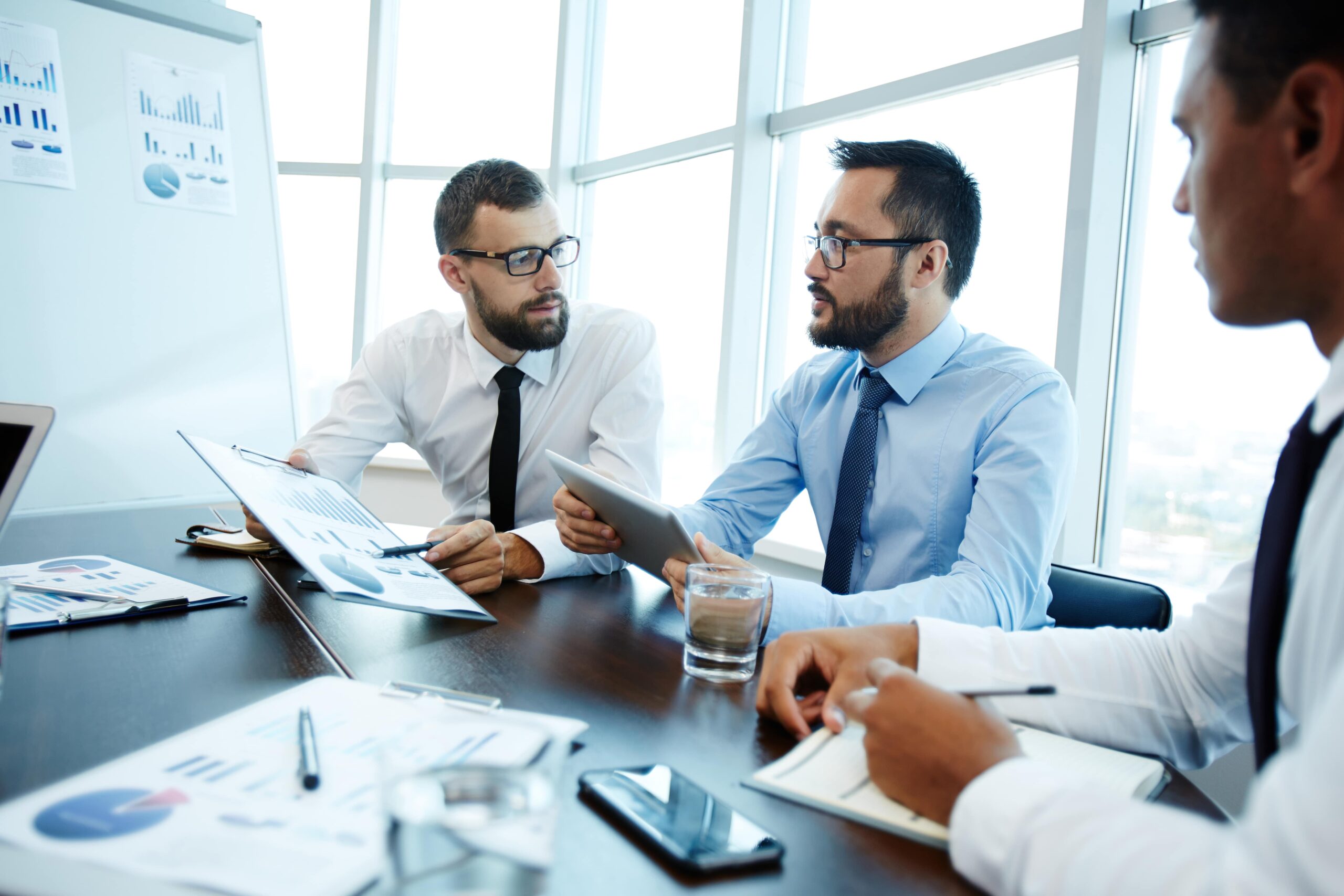 3 pessoas sentadas numa mesa num ambiente empresarial